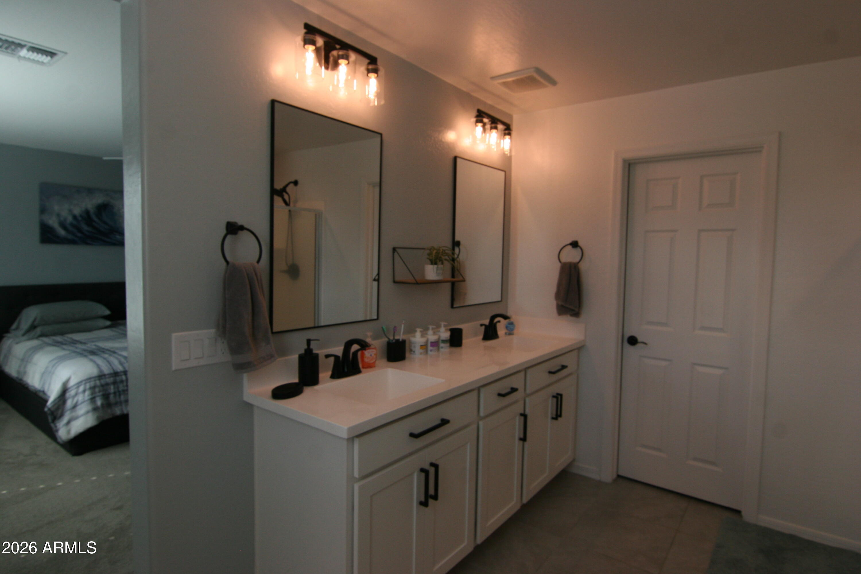 18487 West Ipswitch Way Surprise, AZ 85374 - Photo 5 of 36 a bathroom with double vanity sink and a mirror