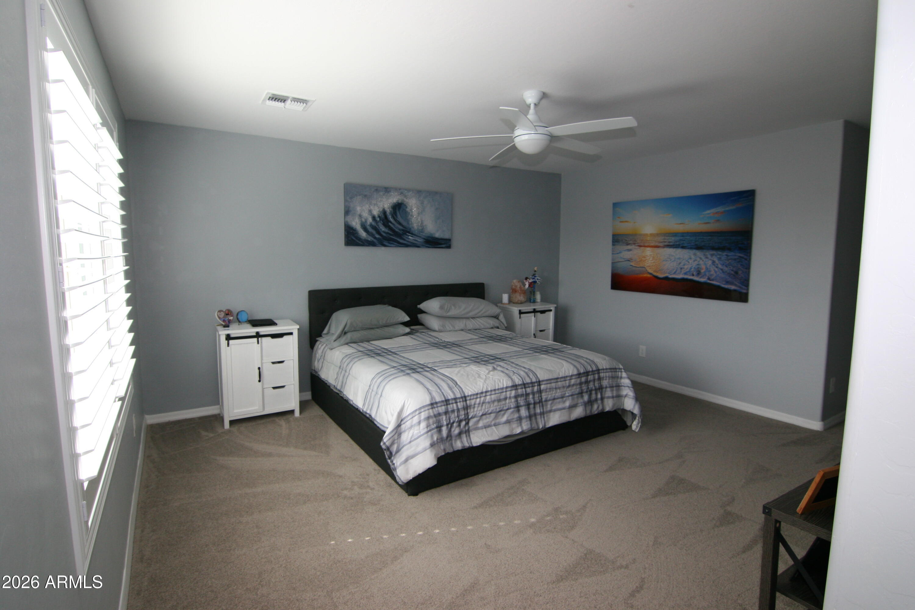 18487 West Ipswitch Way Surprise, AZ 85374 - Photo 6 of 36 a bedroom with a bed and a painting on the wall