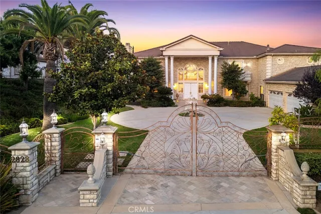 a front view of a house with yard and green space