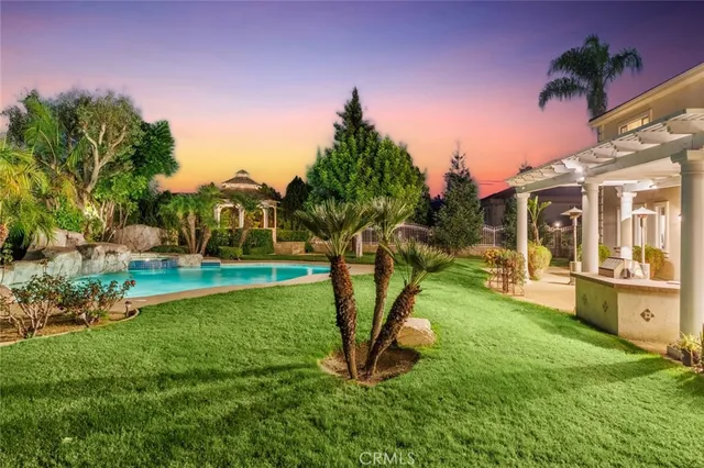 a view of a house with a yard and potted plants