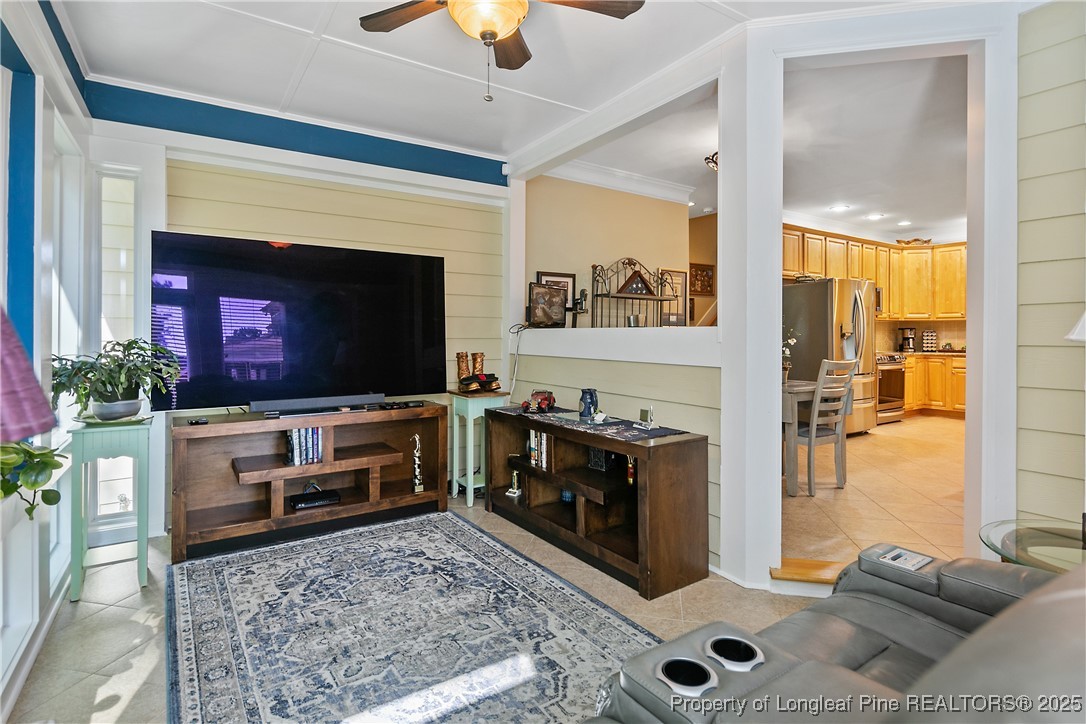 383 Falling Water Road Spring Lake, NC 28390 - Photo 13 of 33 a living room with furniture a flat screen tv and a fireplace