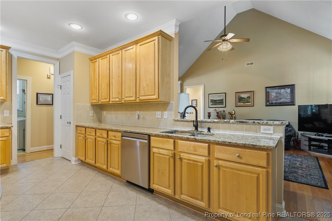 383 Falling Water Road Spring Lake, NC 28390 - Photo 15 of 33 a kitchen with stainless steel appliances granite countertop a sink and cabinets with wooden floor