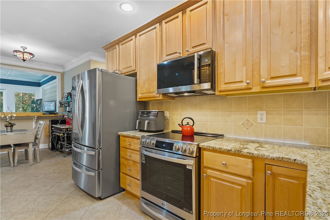 383 Falling Water Road Spring Lake, NC 28390 - Photo 16 of 33 a kitchen with stainless steel appliances granite countertop a refrigerator stove and microwave