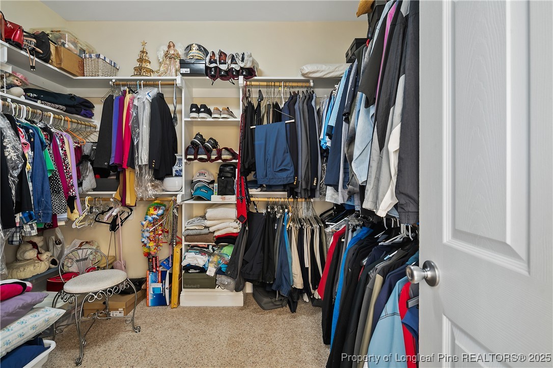 383 Falling Water Road Spring Lake, NC 28390 - Photo 25 of 33 a view of walk in closet with clothes