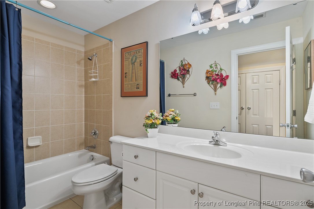383 Falling Water Road Spring Lake, NC 28390 - Photo 31 of 33 a bathroom with a sink mirror toilet and bathtub
