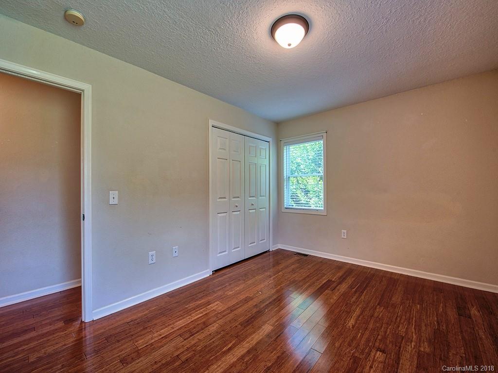 54 Barefoot Ridge Clyde, NC 28721 - Photo 14 of 24 an empty room with wooden floor and windows