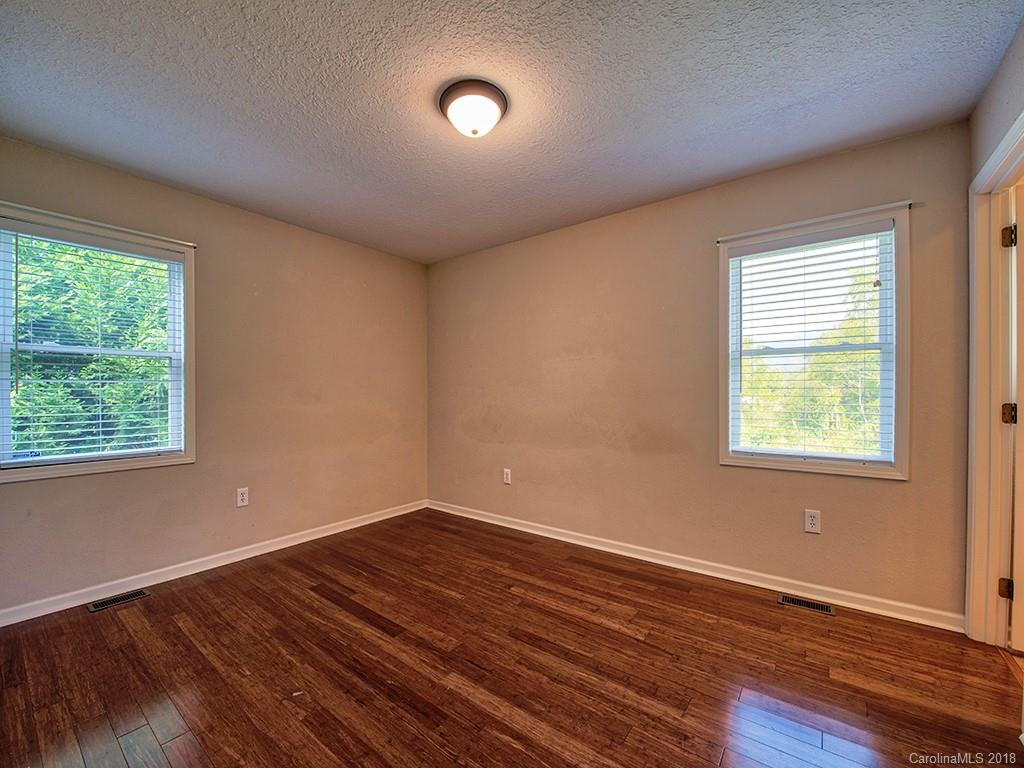 54 Barefoot Ridge Clyde, NC 28721 - Photo 15 of 24 a view of an empty room with wooden floor and a window