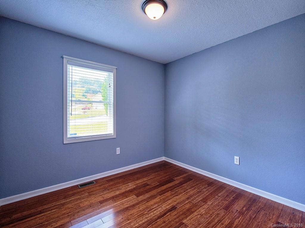 54 Barefoot Ridge Clyde, NC 28721 - Photo 18 of 24 a view of an empty room with wooden floor and a window