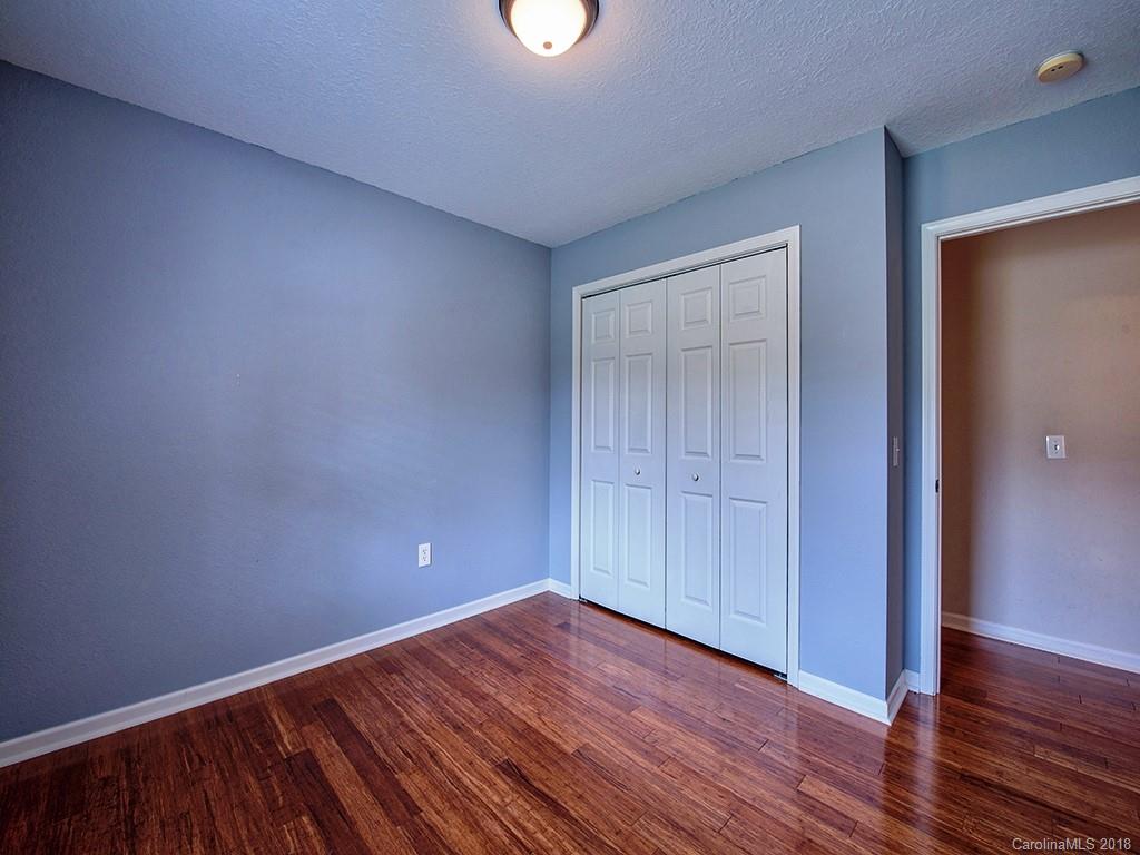54 Barefoot Ridge Clyde, NC 28721 - Photo 19 of 24 a view of an empty room with wooden floor and closet