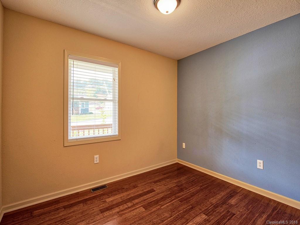 54 Barefoot Ridge Clyde, NC 28721 - Photo 22 of 24 an empty room with wooden floor and windows