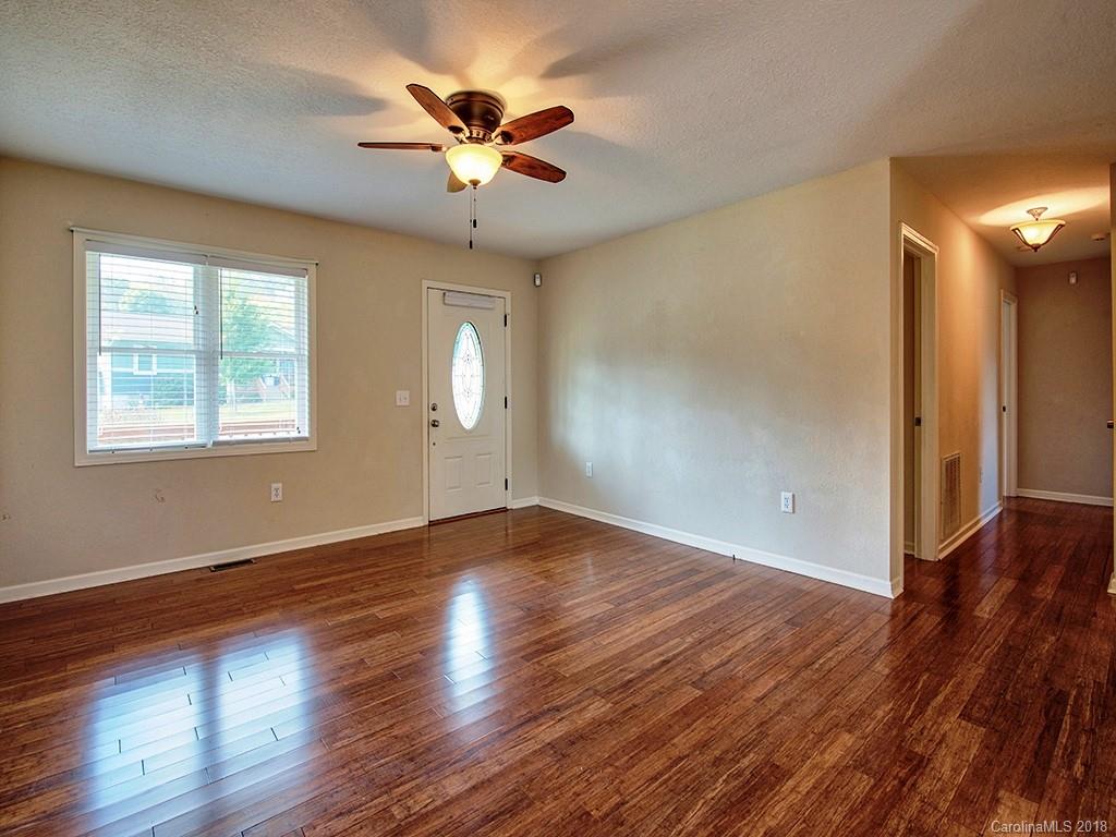 54 Barefoot Ridge Clyde, NC 28721 - Photo 6 of 24 a view of an empty room with wooden floor and a window