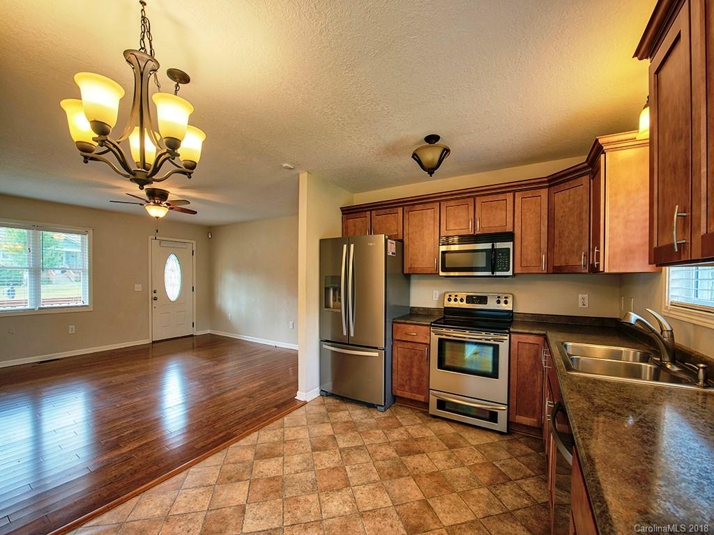 54 Barefoot Ridge Clyde, NC 28721 - Photo 9 of 24 a kitchen with stainless steel appliances granite countertop a refrigerator a stove a sink and a microwave