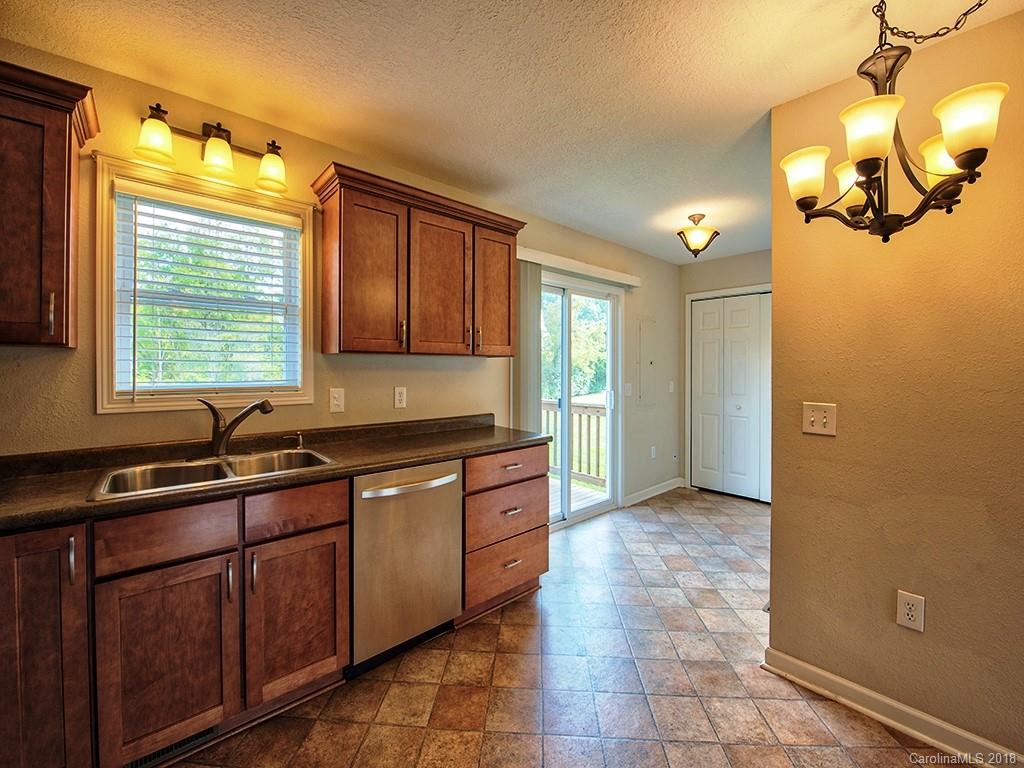 54 Barefoot Ridge Clyde, NC 28721 - Photo 10 of 24 a kitchen with stainless steel appliances granite countertop a sink and cabinets