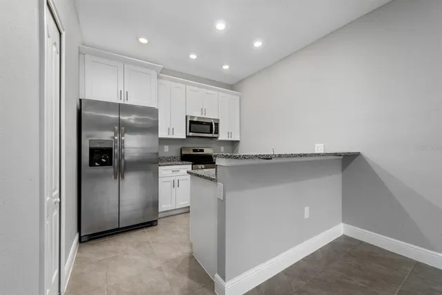 a kitchen with cabinets and stainless steel appliances