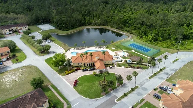 an aerial view of a house with yard