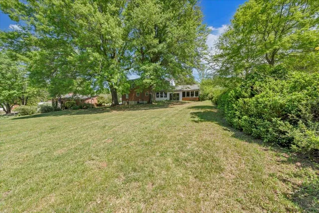 a kitchen with granite countertop sink stove and cabinets
