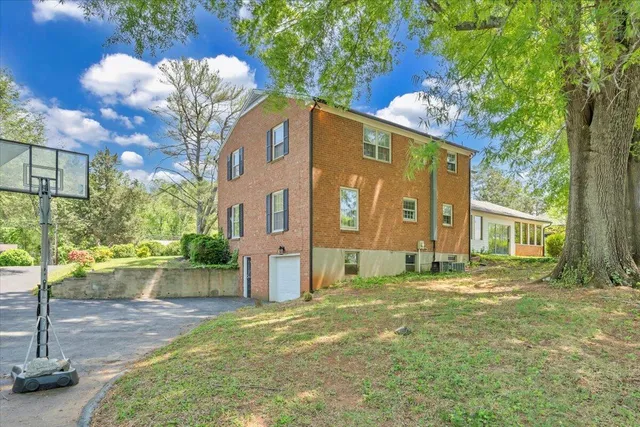 a kitchen with stainless steel appliances granite countertop a stove a sink dishwasher and a refrigerator with wooden floor