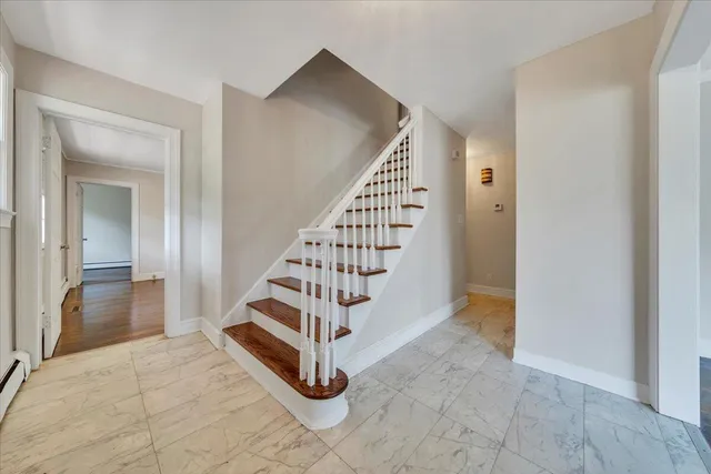 a view of a bedroom with wooden floor and windows