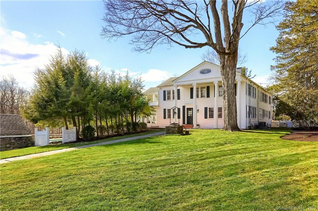 249 Nod Road Ridgefield, CT 06877 - Photo 1 of 1 a view of a house with a big yard and large trees