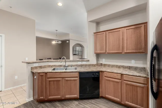 a kitchen with stainless steel appliances granite countertop a sink stove and cabinets