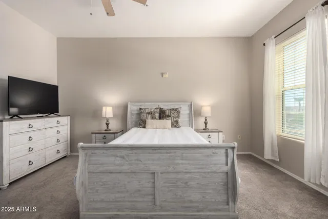 a bedroom with a bed and flat screen tv