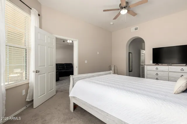 a bedroom with a bed and a flat screen tv