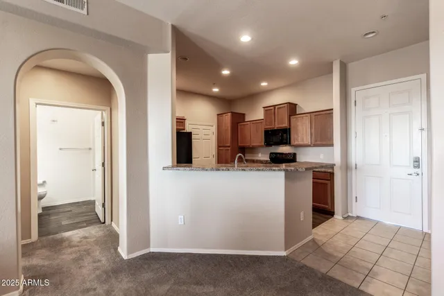 a view of kitchen with refrigerator stove and wooden floor