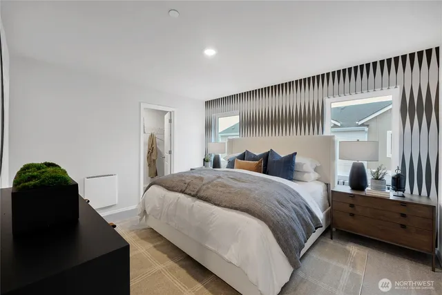 a spacious bedroom with a bed and a large window