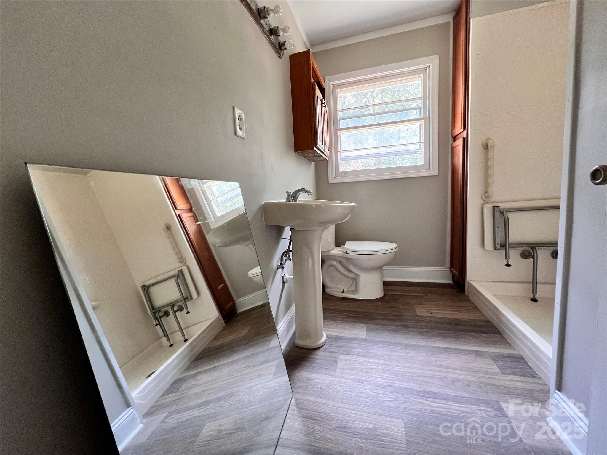 405 West Inwood Street Bethune, SC 29009 - Photo 11 of 22 a bathroom with a toilet sink and mirror