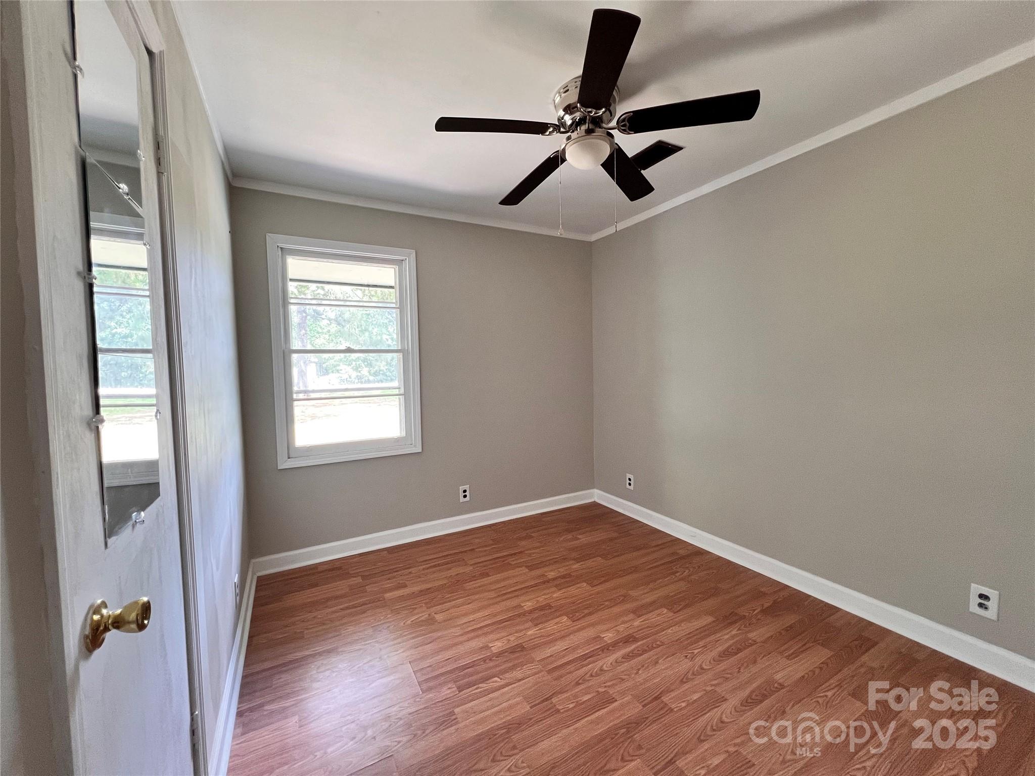 405 West Inwood Street Bethune, SC 29009 - Photo 12 of 22 wooden floor in an empty room with a window