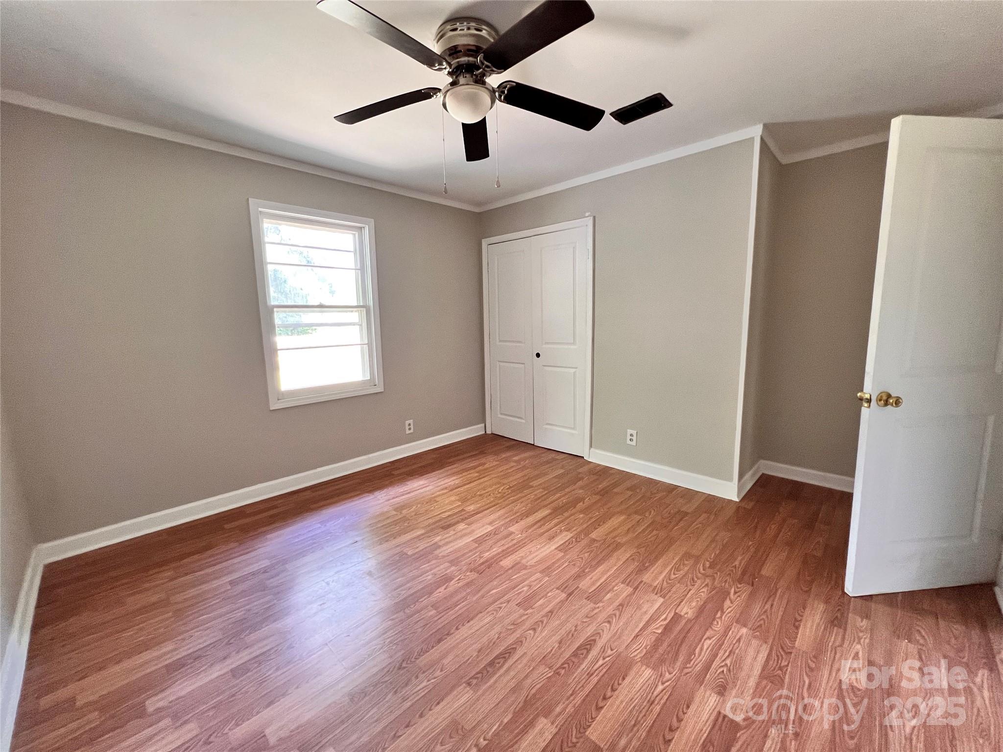 405 West Inwood Street Bethune, SC 29009 - Photo 13 of 22 a view of an empty room with wooden floor and a window