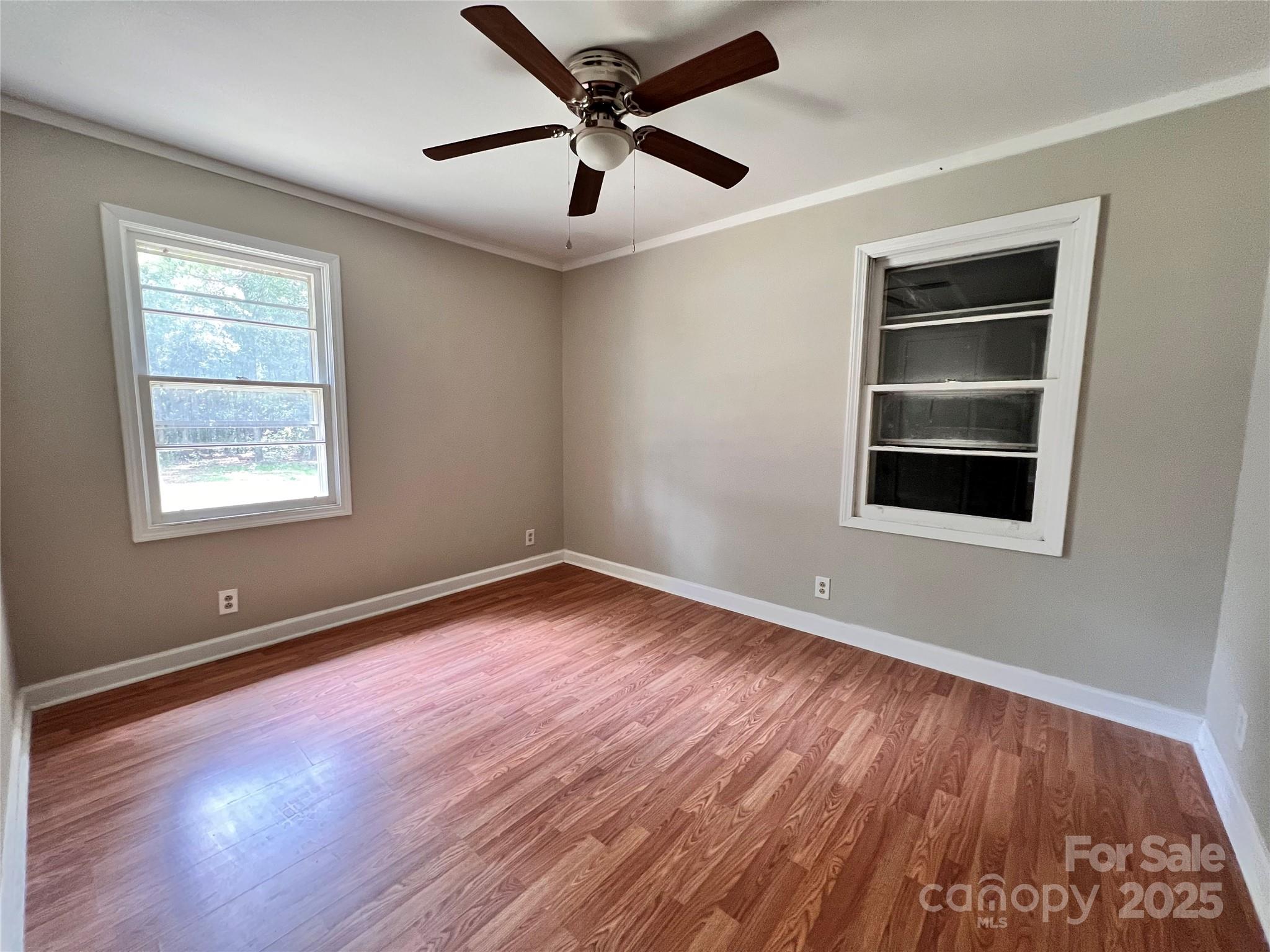 405 West Inwood Street Bethune, SC 29009 - Photo 15 of 22 a view of an empty room with a window and wooden floor