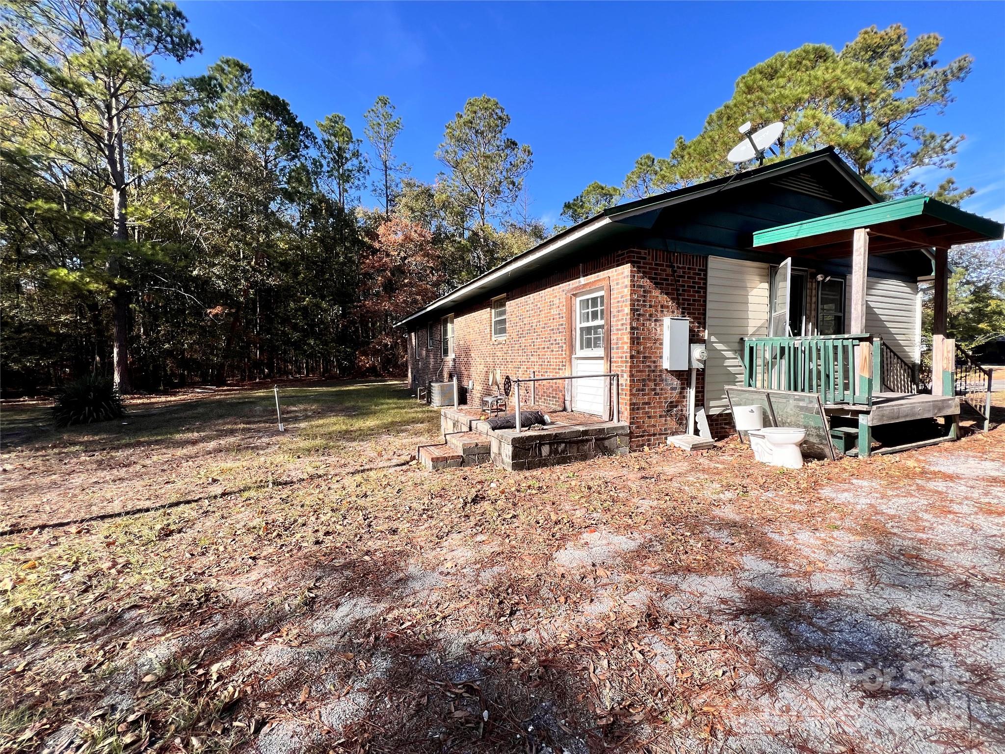 405 West Inwood Street Bethune, SC 29009 - Photo 19 of 22 a view of a house with backyard and sitting area