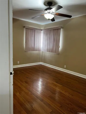 a view of wooden floor and windows in a room
