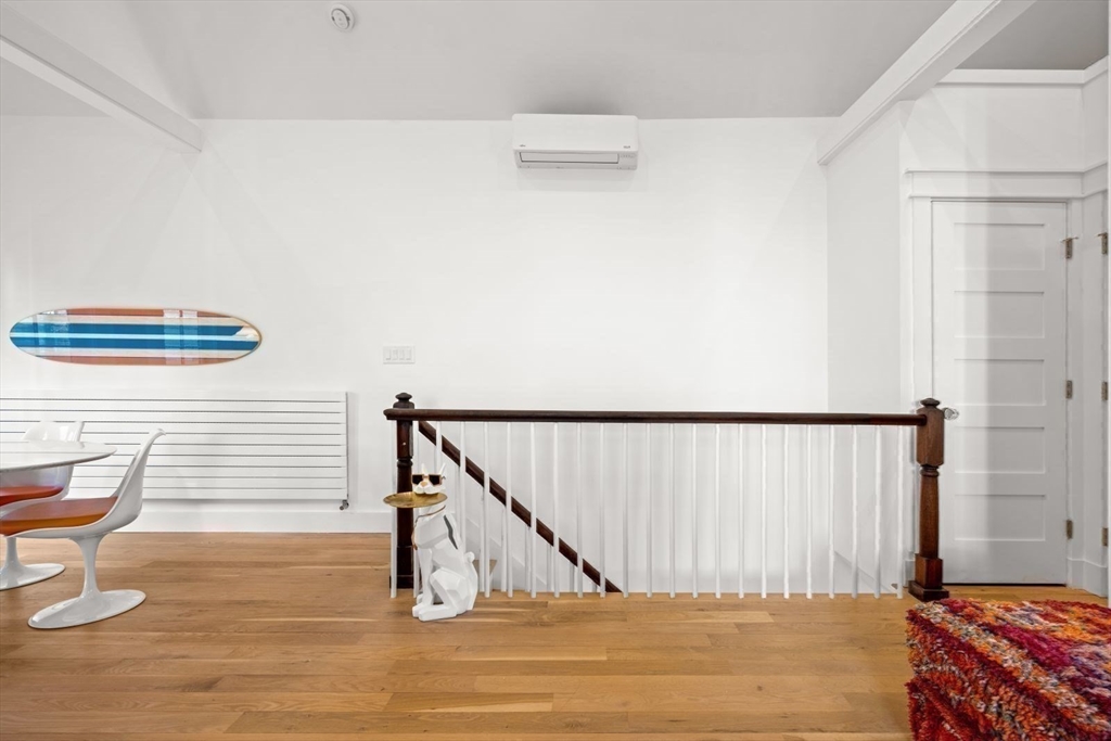 22 Mitchell Street, Unit 1 Boston, MA 02127 - Photo 15 of 41 a bedroom with a bed and chair