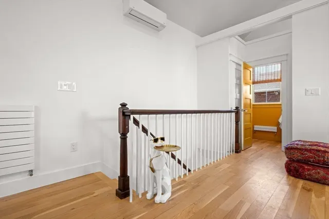 a view of entryway and hall with wooden floor