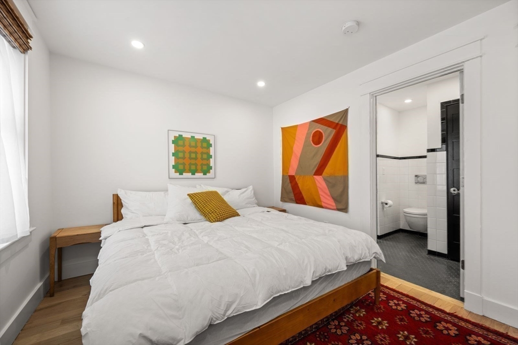 22 Mitchell Street, Unit 1 Boston, MA 02127 - Photo 20 of 41 a bedroom with a bed and wooden floor