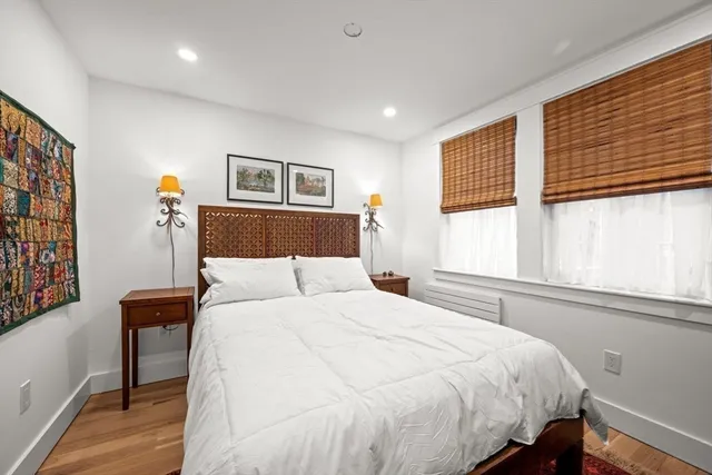 a bedroom with a bed and a large window