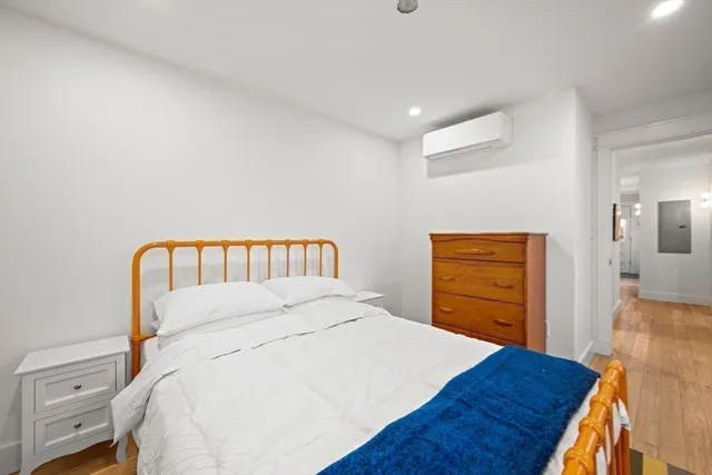 a bedroom with a bed and a dresser