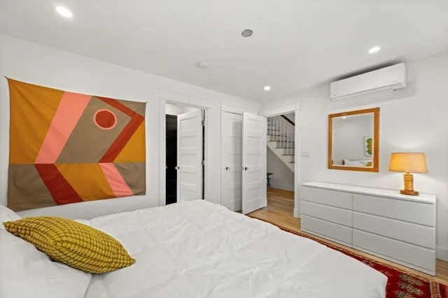 a bedroom with a bed and a dresser