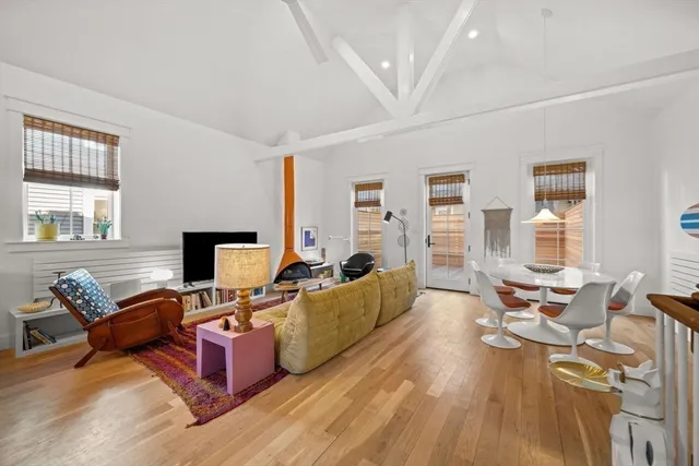 a living room with furniture fireplace and a window