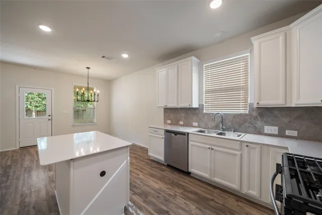 a view of empty room with wooden floor window and fireplace