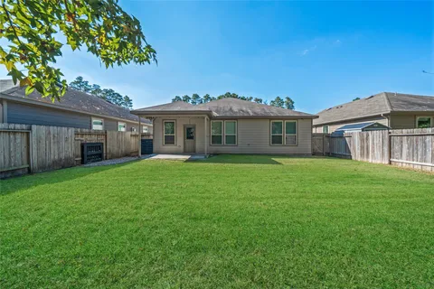a front view of a house with a garden and yard