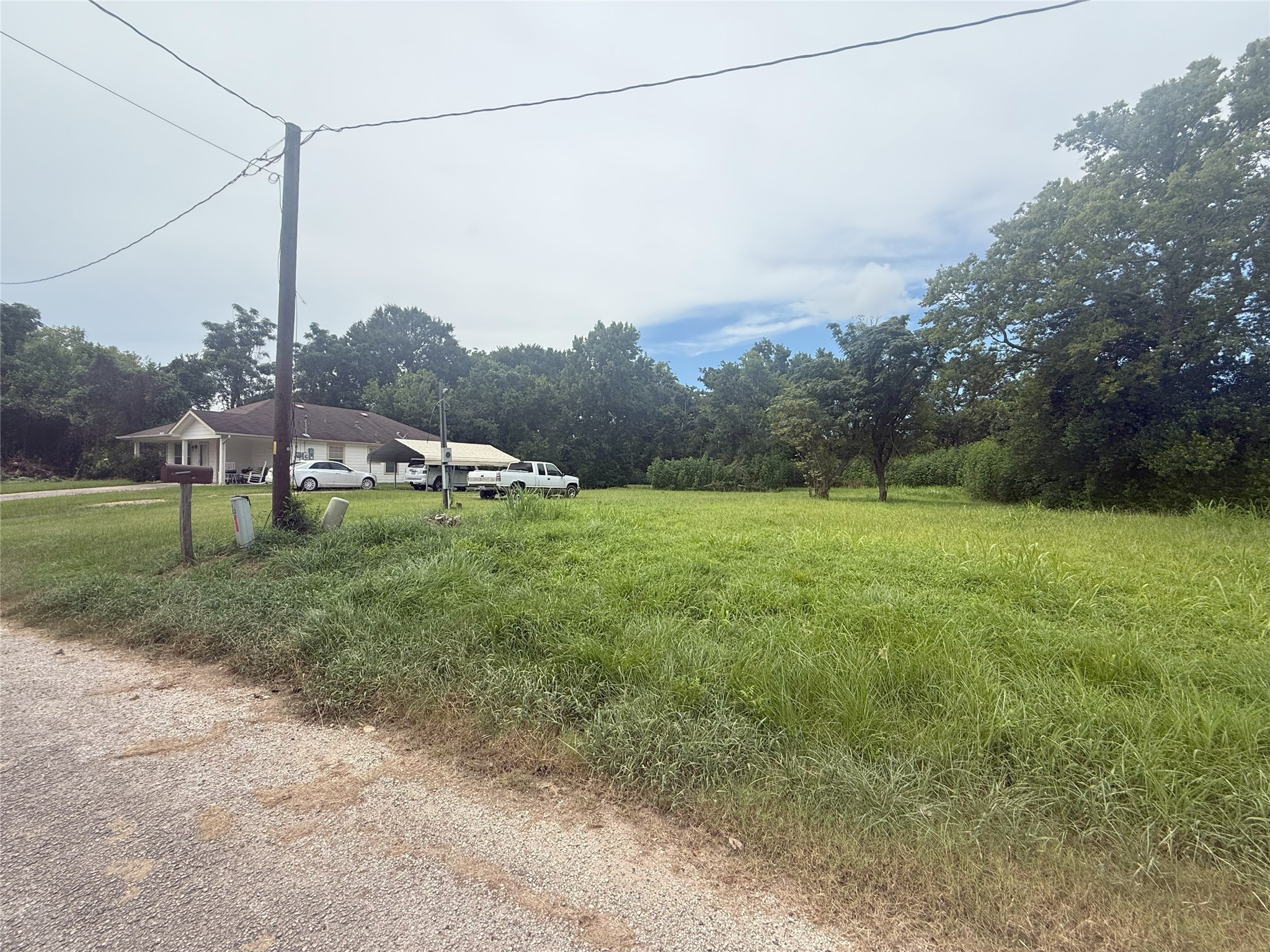 611 Trinity Street Liberty, TX 77575 - Photo 3 of 4 a view of a field with a tree in the background