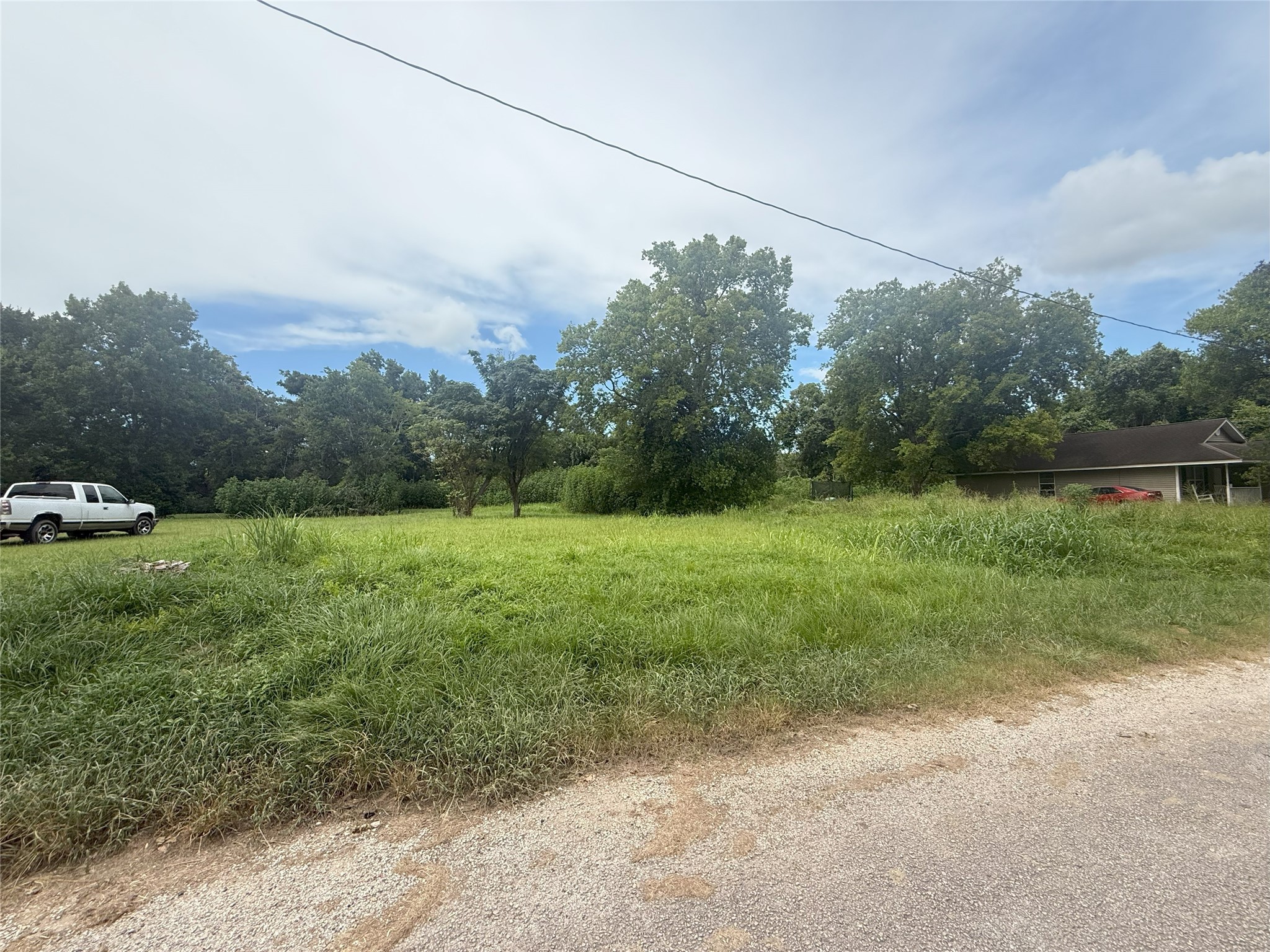 611 Trinity Street Liberty, TX 77575 - Photo 4 of 4 a view of a field with a tree in the background
