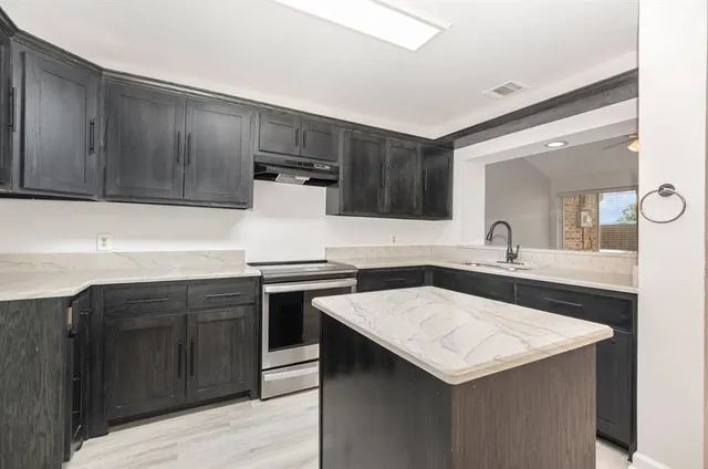a kitchen with a stove and a sink