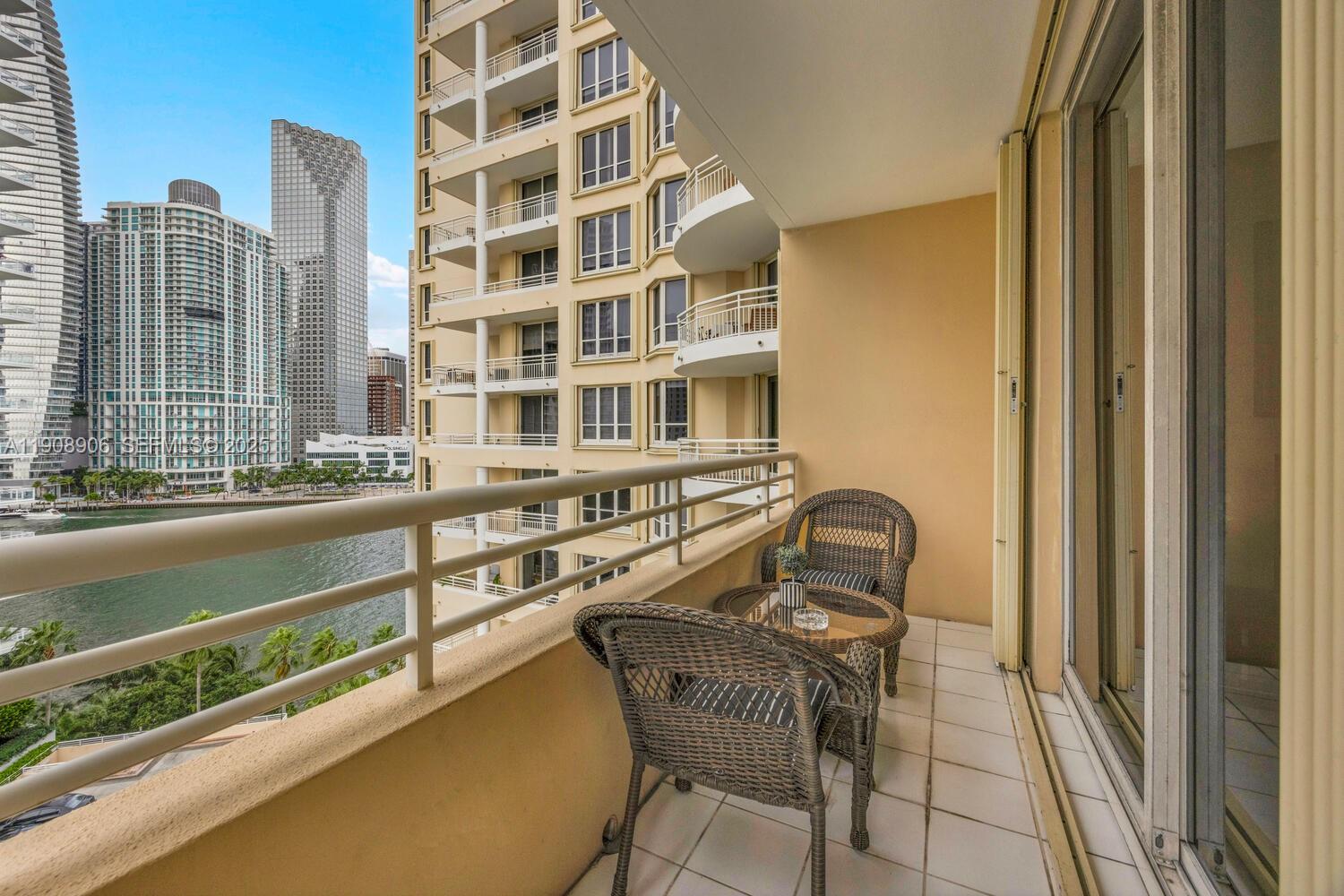 888 Brickell Key Drive, Unit 1001 Miami, FL 33131 - Photo 13 of 15 a view of a balcony with table and chairs