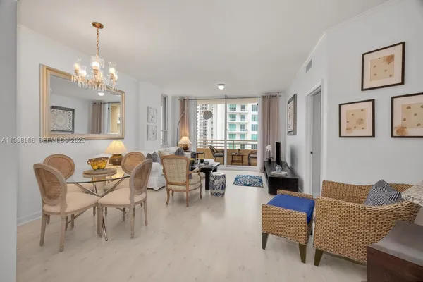 a living room with furniture and kitchen view
