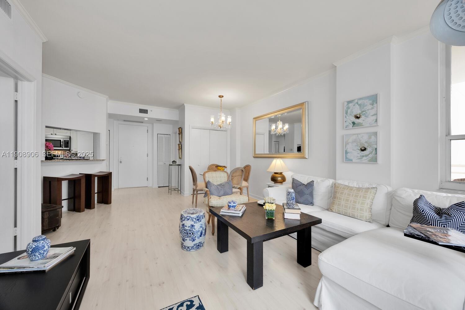 888 Brickell Key Drive, Unit 1001 Miami, FL 33131 - Photo 8 of 15 a living room with furniture and kitchen view