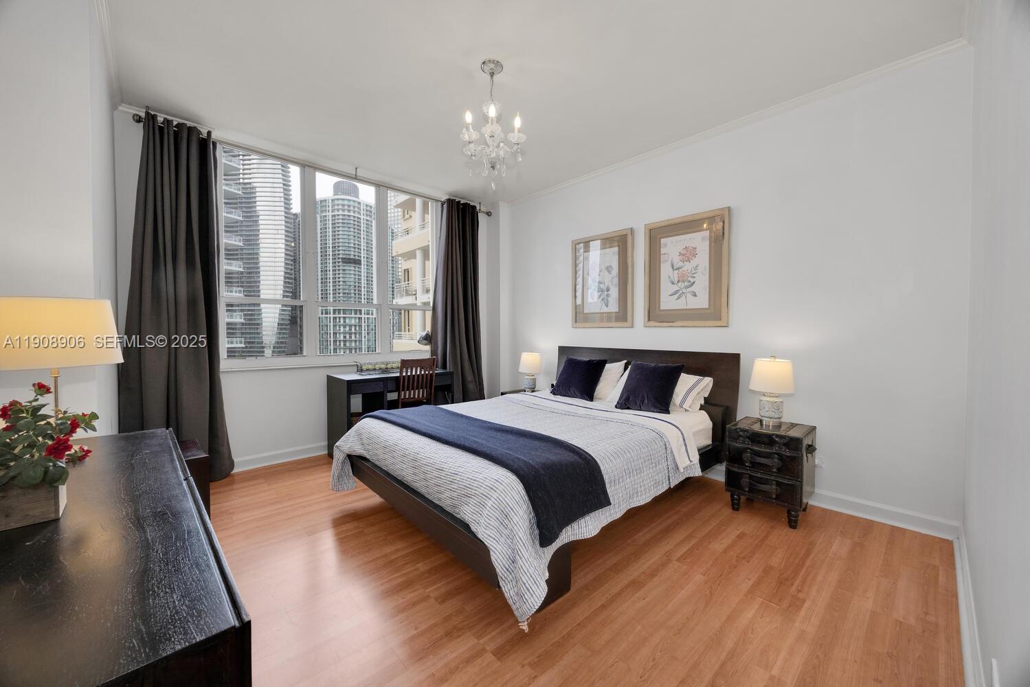 888 Brickell Key Drive, Unit 1001 Miami, FL 33131 - Photo 10 of 15 a bed room with a bed and a window